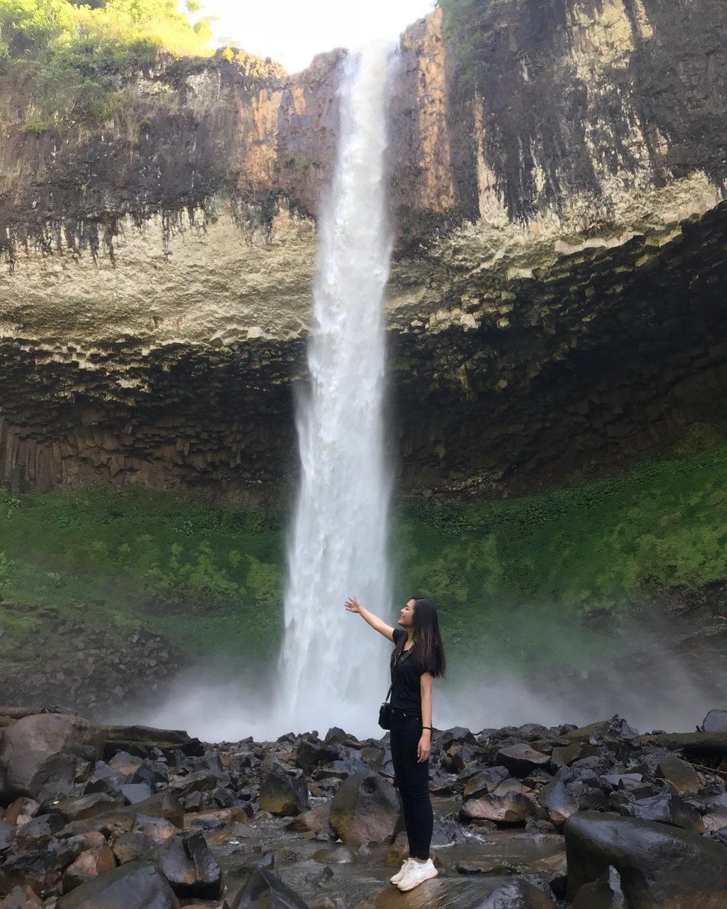 The flow of the waterfall creates a beautiful image like a strip of white silk lying across the craggy rocks.