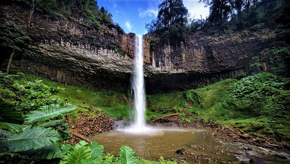 The waterfall is about 30m high and flows down rocky slopes.