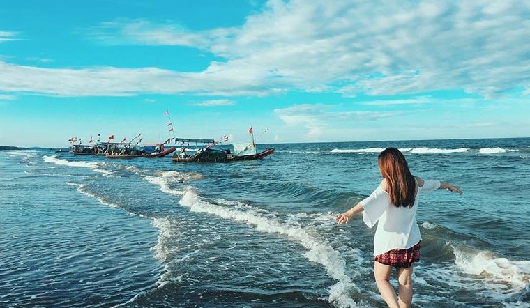 Beautiful pristine beach, clear blue water, gentle waves.