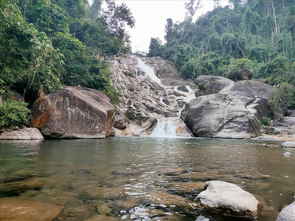 The waterfall poured down with the clear water, creating a hundred meters long and quiet